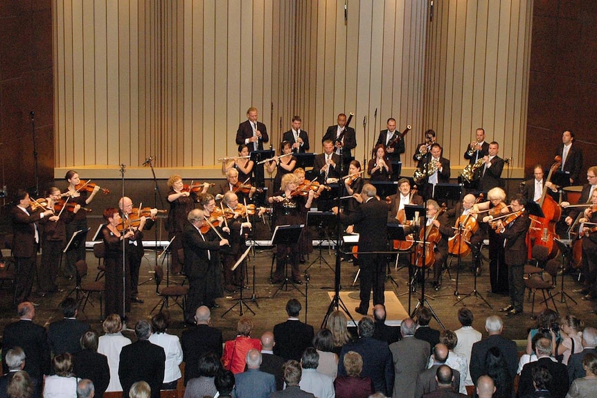 Roberto Paternostro conducts orchestra during historic concert