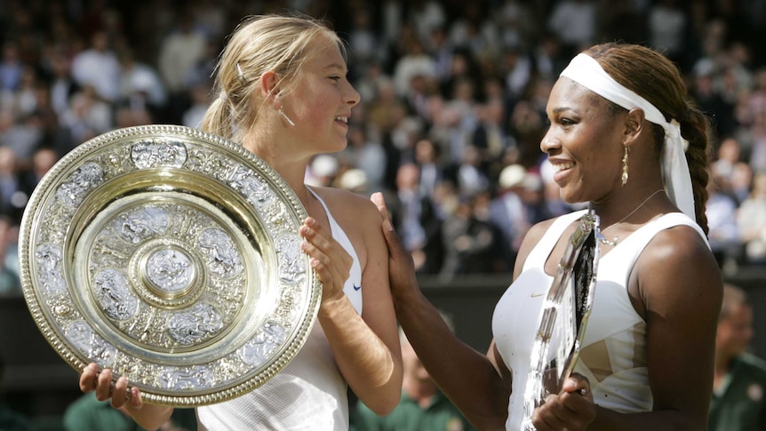 Maria Sharapova with the 2004 Wimbledon trophy alongside Serena Williams