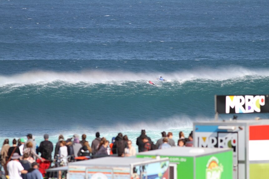 Kelly Slater and Australian surfer Jack Freestone  paddle over a wave