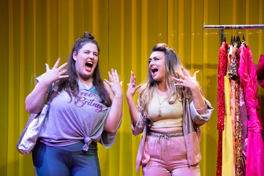 Brightly-lit stage shot of two women