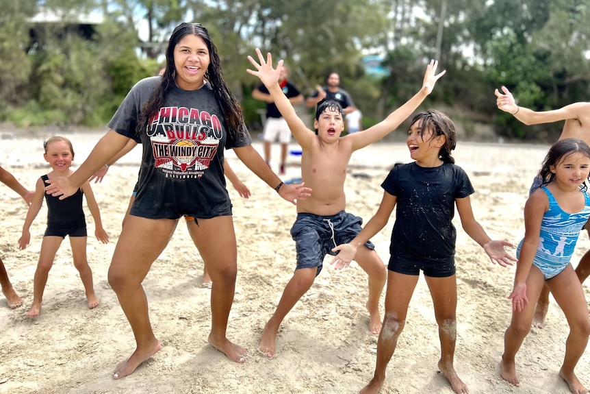 Aboriginal kids dance on the sand 
