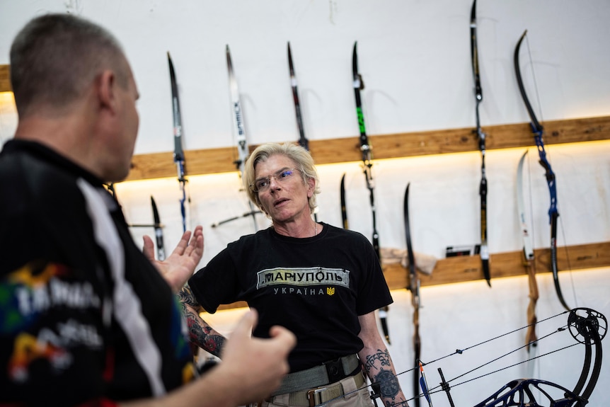 Yuliia Paievska speaks to archery coach