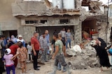 Iraqis gather at bomb site in Kirkuk