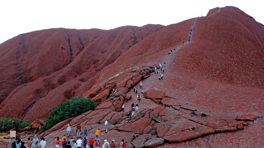 Although against the wishes of the traditional owners, tourists flock to Uluru to climb to the top of the rockin 2006.