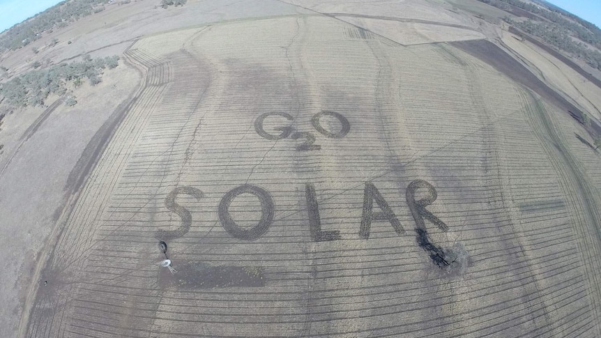 A farmer ploughs a climate change message for G20 organisers.