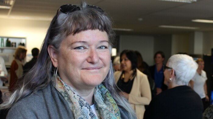 Lee Banfield in front of a group of older women at the launch of a housing initiative.