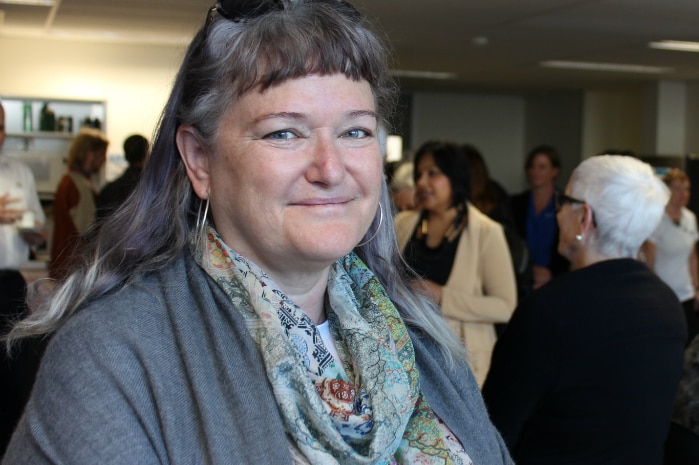 Lee Banfield in front of a group of older women at the launch of a housing initiative.