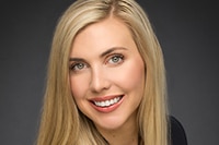 A woman with long blonde hair smiling