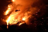 A Los Angeles County fire helicopter makes a night drop while battling the so-called Fish Fire.