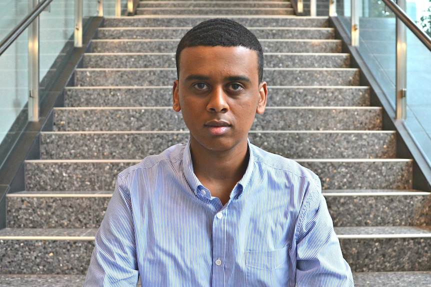 Ahmed Hassan sits on a staircase.