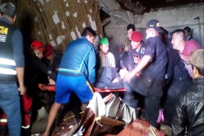 Rescuers remove the injured from a hotel in Peru.