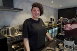a woman inside a cafe looking and smiling