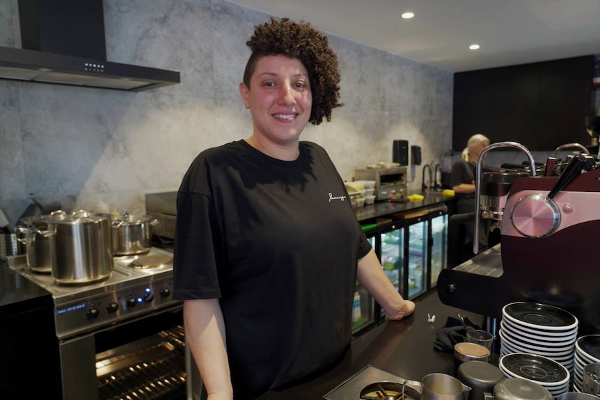 a woman inside a cafe looking and smiling