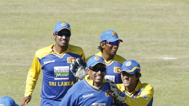 Sri Lankan players celebrate after taking the wicket of Zimbabwean batsman Brendan Taylor.