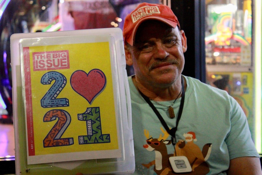 A vendor sells the first 2021 edition of The Big Issue on the streets of Fremantle on NYE.