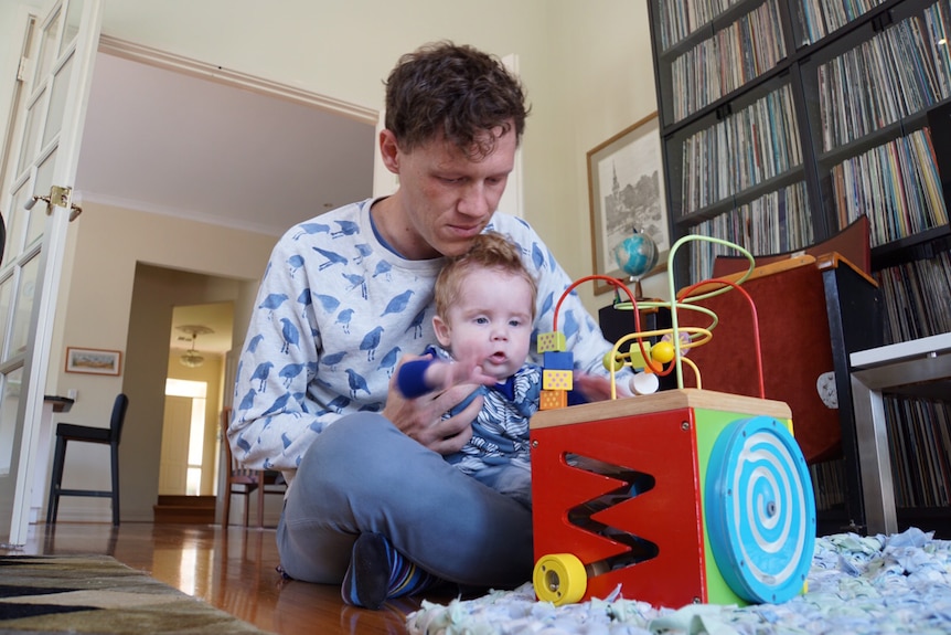 New father Ben Jones will stay at home with Angus after his employer brought in a new parental leave policy.