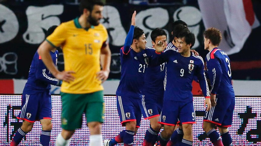 Mile Jedinak shows his disappointment after Japan's Shinji Okazaki scores in Osaka.
