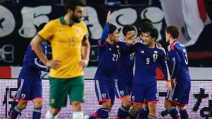 Japan celebrates Shinji Okazaki's goal against the Socceroos