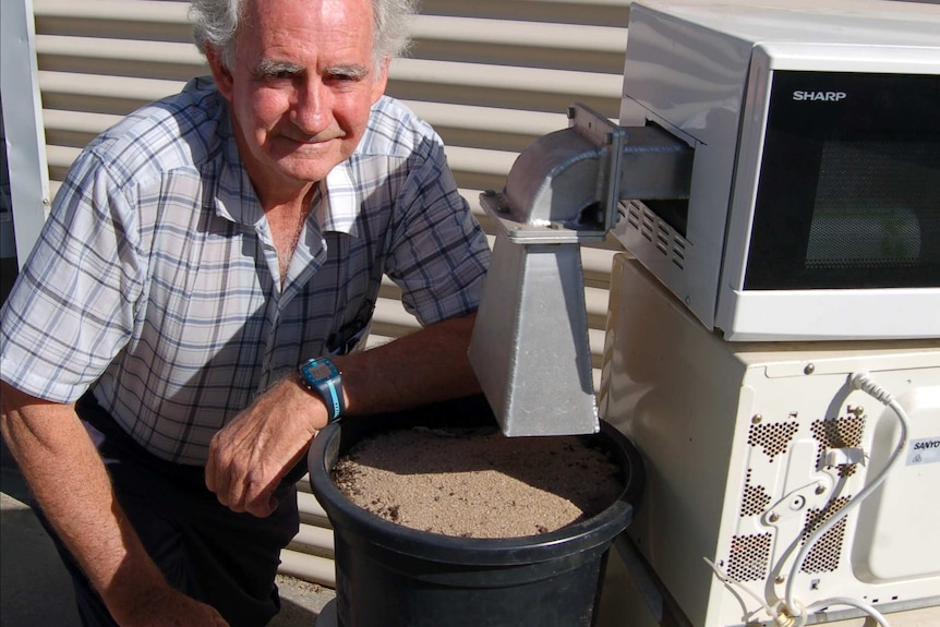 Researcher John Moore with snail microwave