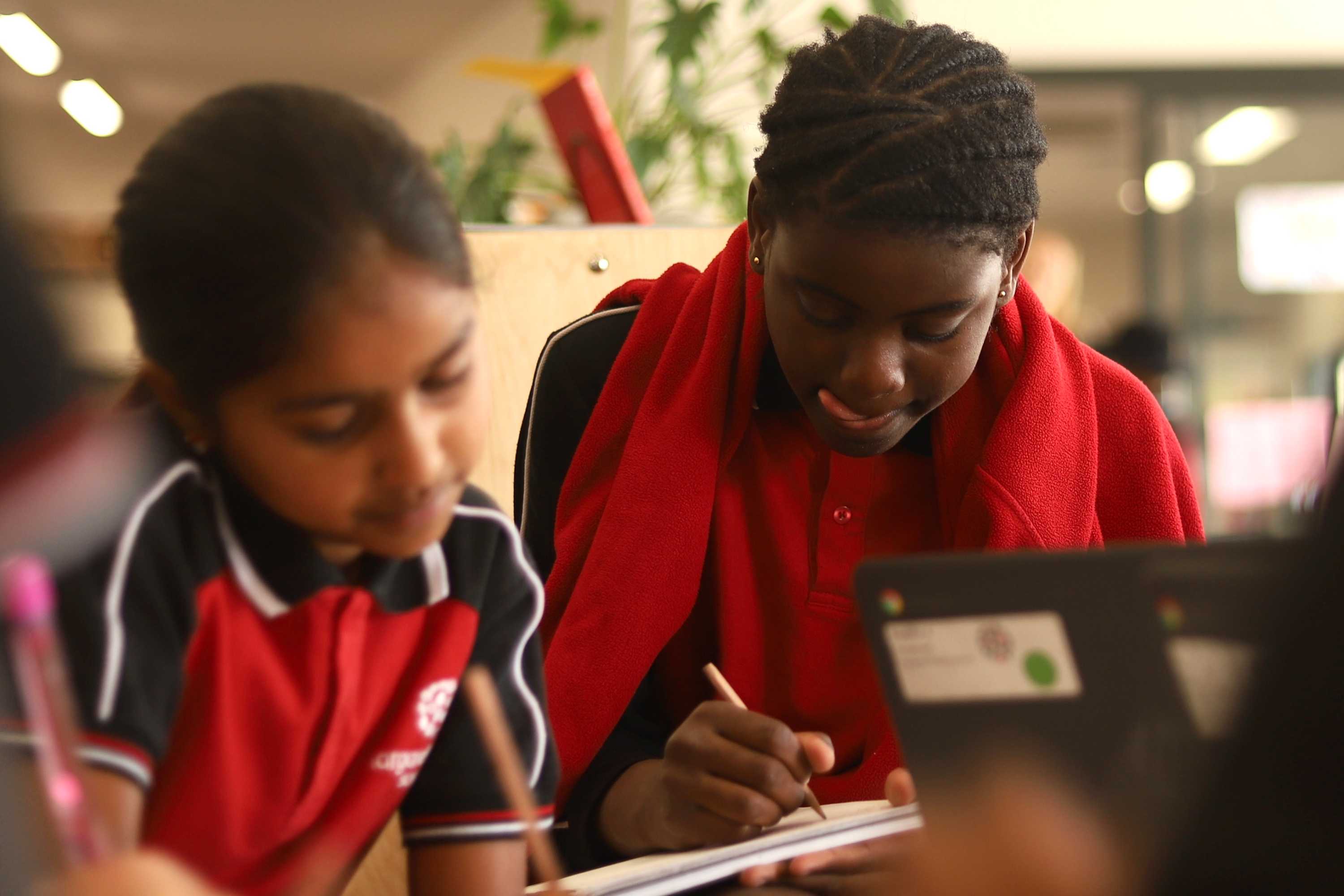Students concentrate at their desks on school work.