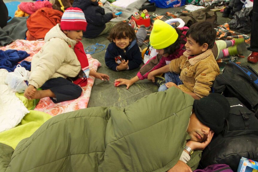 Asylum seekers sleep on the station floor in Vienna