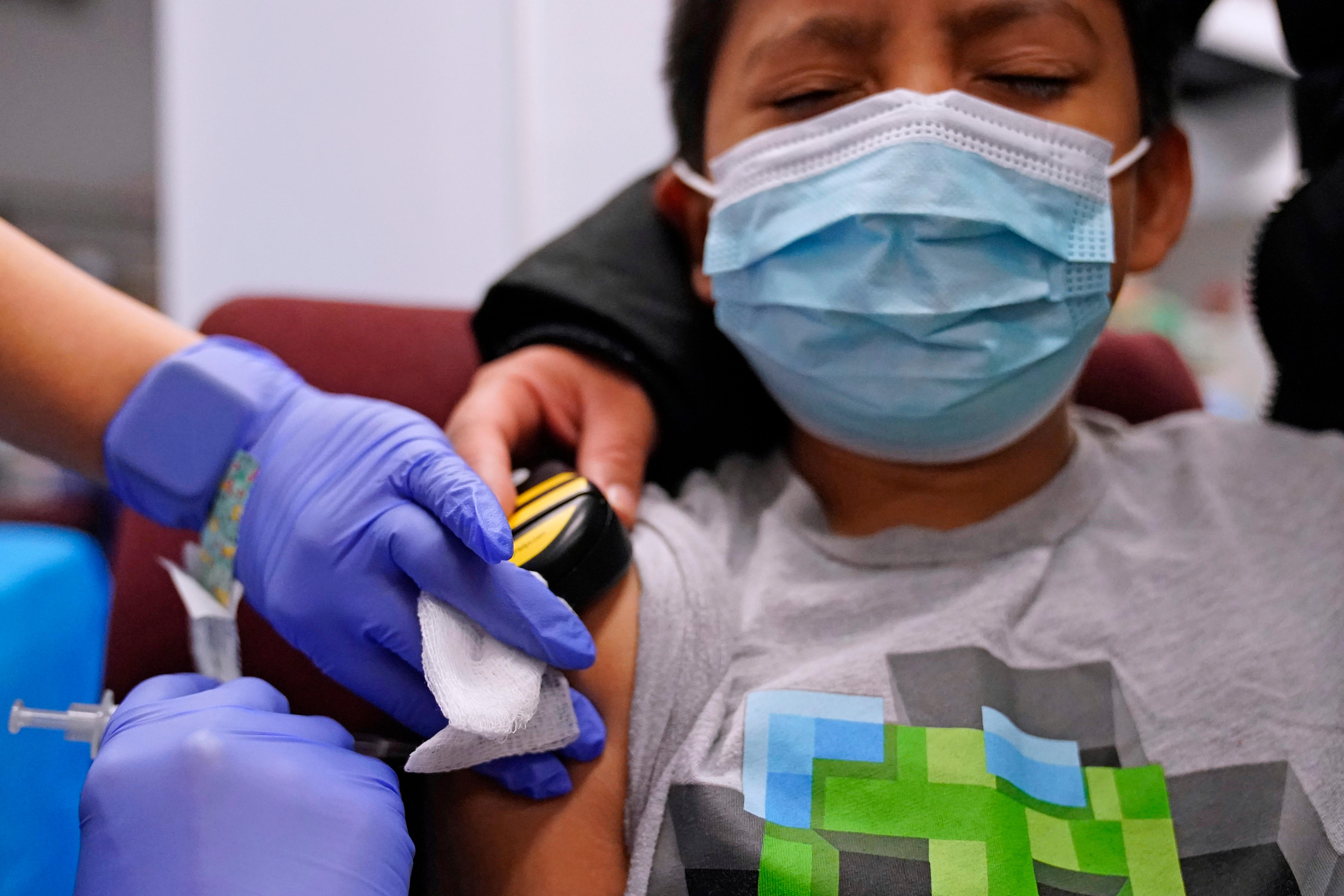 A child closes his eyes as he receives a Pfizer vaccine in Illinois, December 2021.
