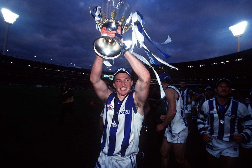 Brent Harvey holds the 1999 AFL premiership cup
