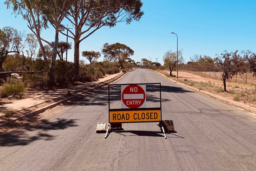 A road closed sign sitting in the middle of a road in rural South Australia