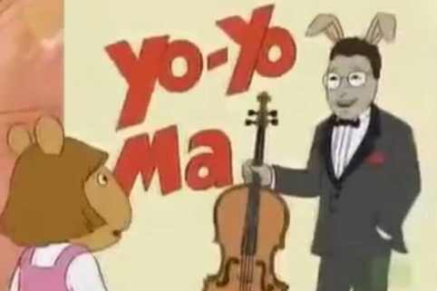 A scene from cartoon series Arthur, featuring a poster depicting Yo-Yo Ma as a rabbit, with DW looking on.