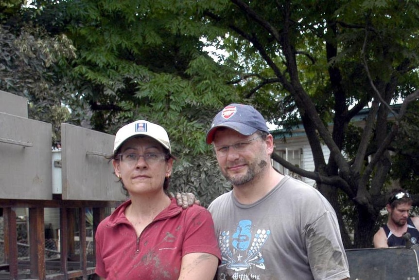 Wendy Schultz and Darren Hawkins outside their flooded home