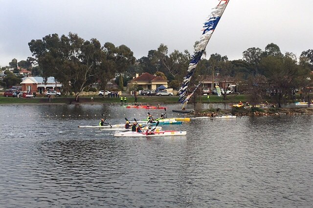 About six kayakers paddle down the Avon River in Northam during the Avon Descent.