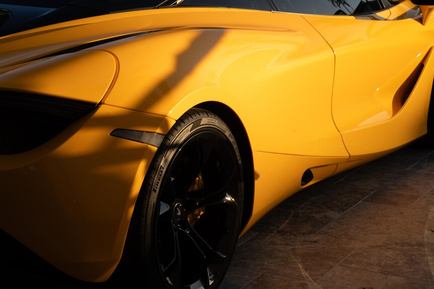 A side-on angle of an orange sports car.