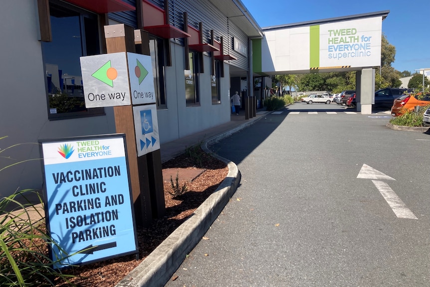 The outside of a medical clinic, with signs for a vaccination clinic.