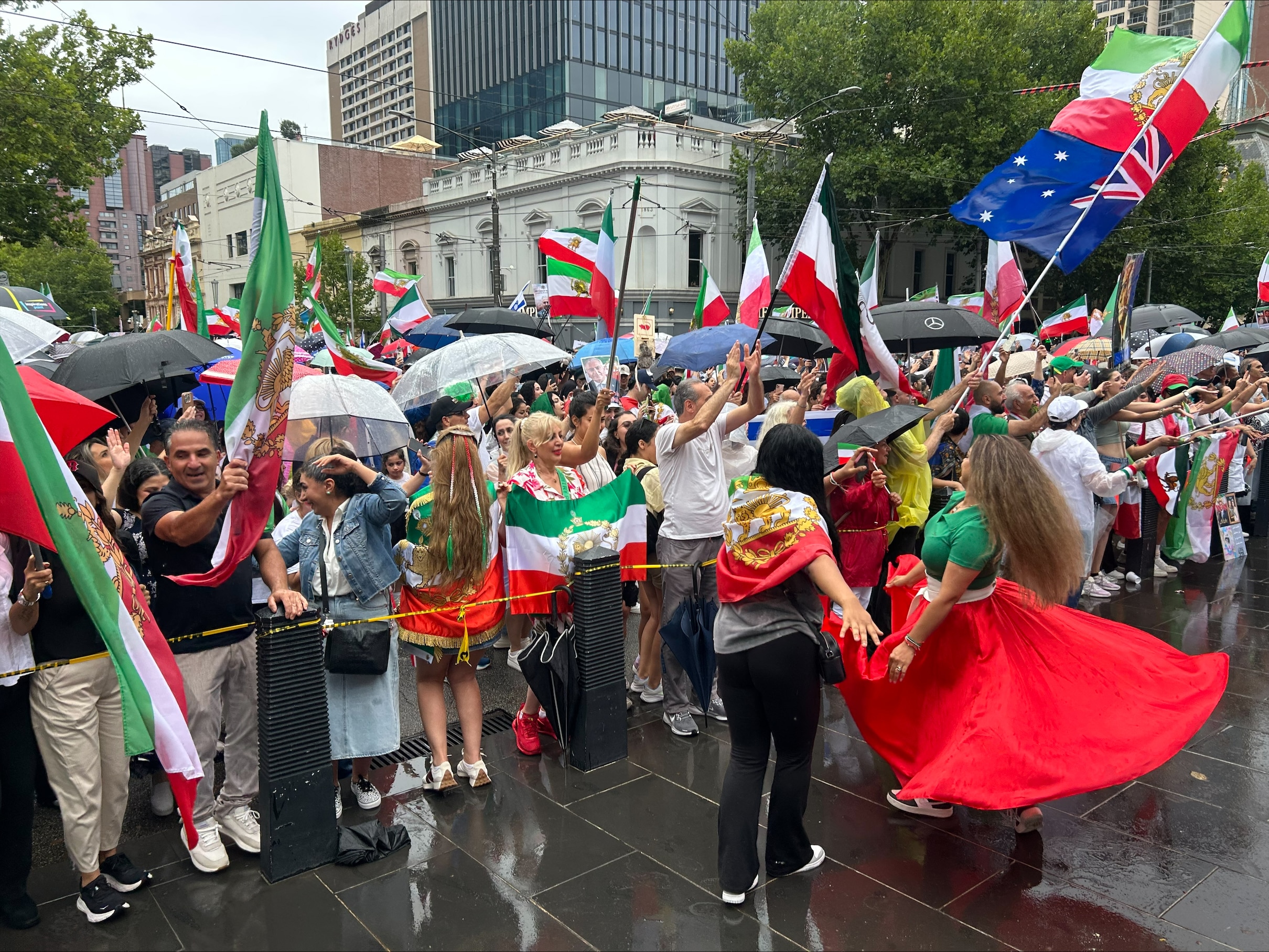 The crowd in Melbourne sang the national anthem and danced in the rain.
