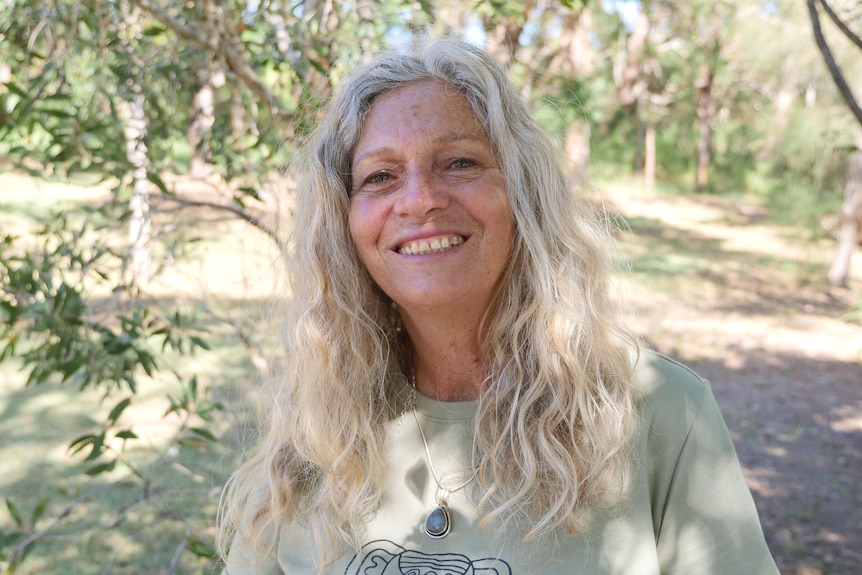 A woman smiles at the camera.