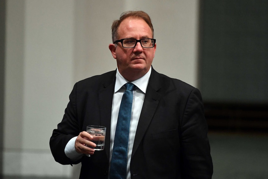 David Feeney holds a glass of water during Question Time in the House of Representatives.