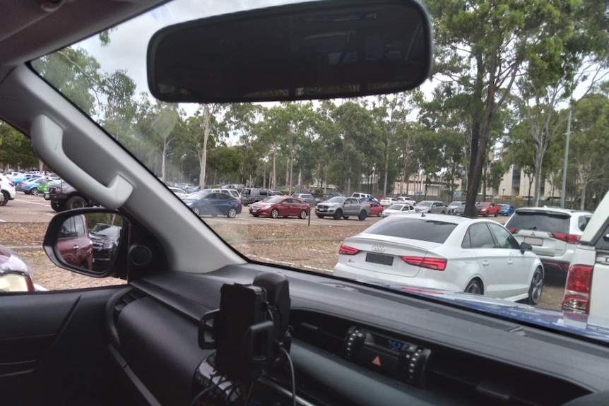 The view from inside a car that shows a long line of vehicles.