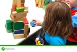 A child plays with blocks