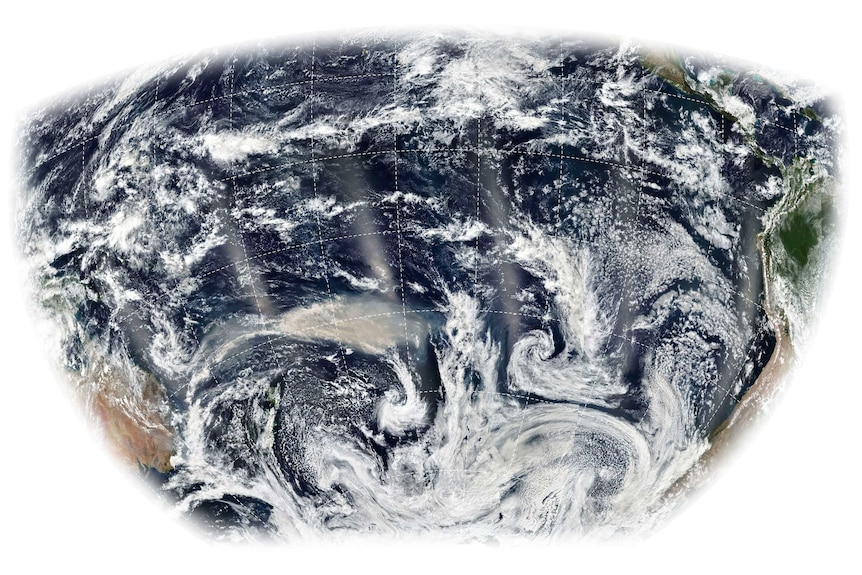 A satellite image of the southern hemisphere with smoke over the Pacific Ocean