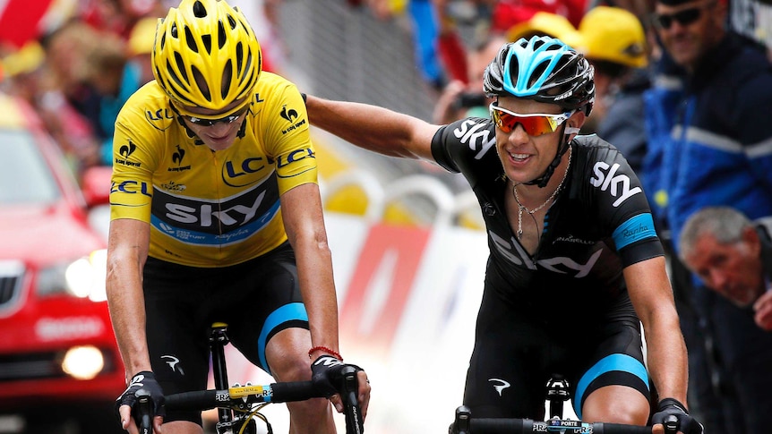 Richie Porte embraces Christopher Froome as they cross the finish line of the 18th stage.