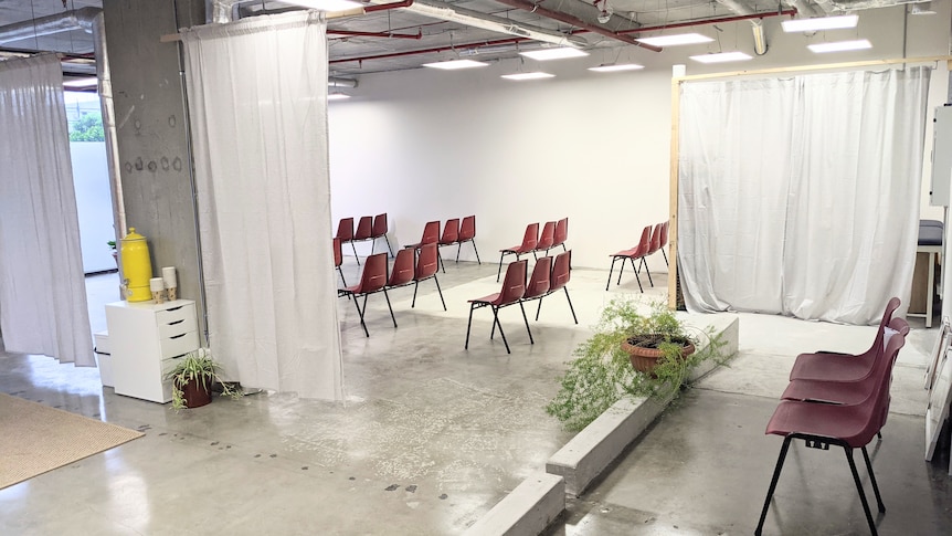 A retail space with chairs and cubicles.