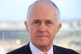 A tight head shot of Prime Minister Malcolm Turnbull outdoors during a media conference.