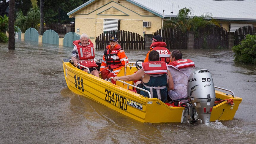 SES volunteers rescue residents from their flooded properties in Rosslea in Townsville in north Queensland.