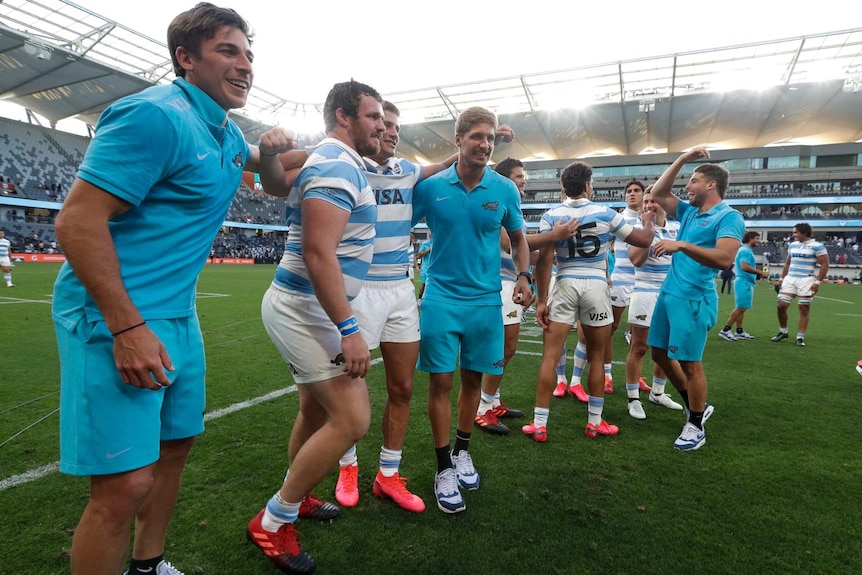 Argentina players on the field after beating the All Blacks