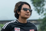 Mariyam Mohamed in a Maldives football kit and sunglasses.