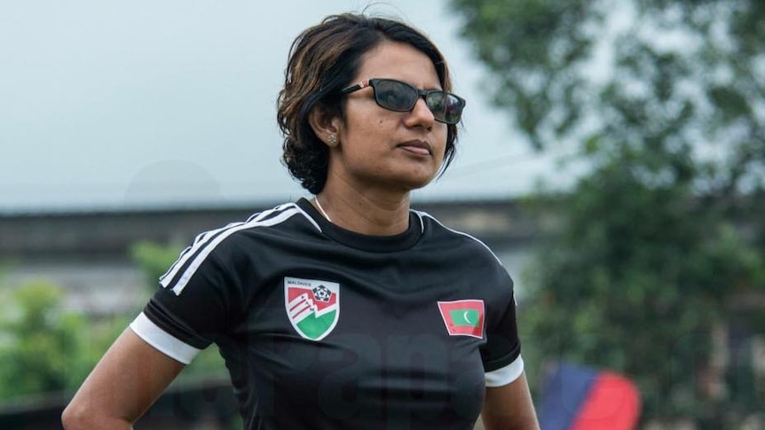 Mariyam Mohamed in a Maldives football kit and sunglasses.