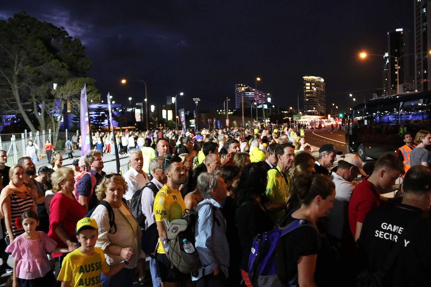 Thousands of people waiting at a Commonwealth Games bus stop