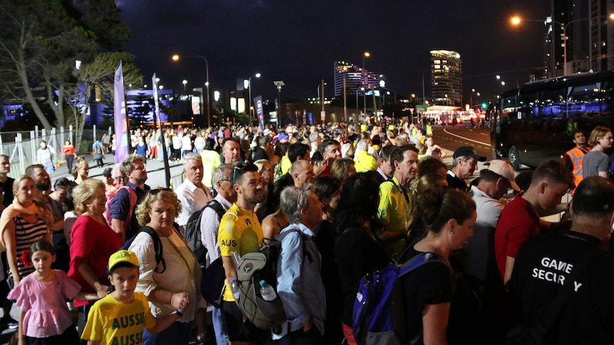 Thousands of people waiting at a Commonwealth Games bus stop