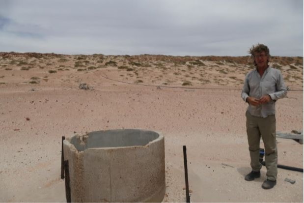 Man standing next to well on his station in Gnaraloo.