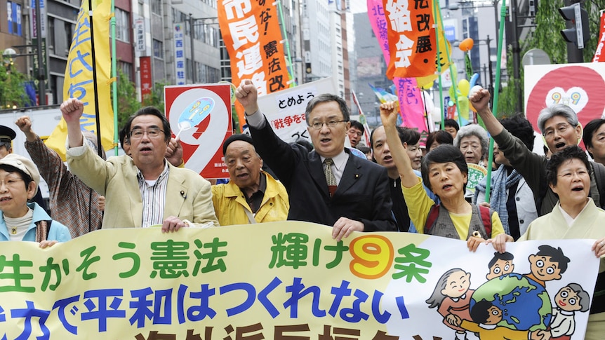 Protesters shout slogans during their demonstration march to support the war-renouncing Japanese constitution